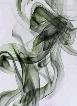 green and black smoke rising across a light colored background