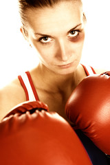  Sepia picture of a woman boxer with a bruise on her face