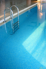 Indoor pool with a ladder and transparent water