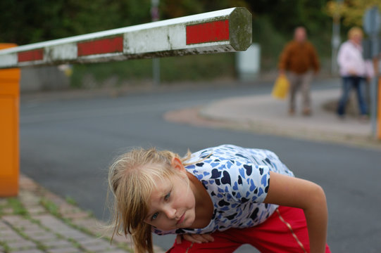 kind unter schlagbaum