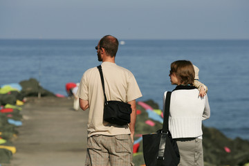 Fototapeta premium couple avec son enfant qui regarde la mer
