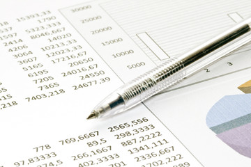 pen showing diagram on financial&business report/magazine