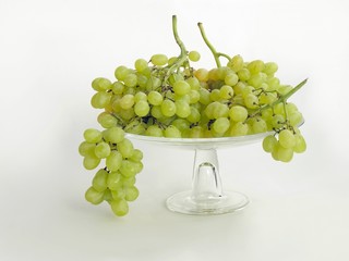 green sweet grapes on glass plate