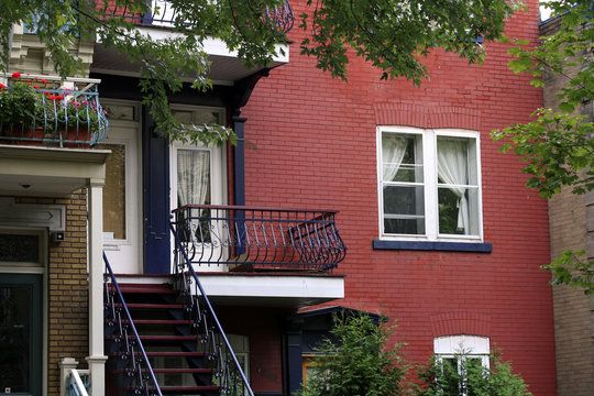 Red brick apartments with typical balconies in Montreal