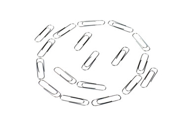 Smiling face made up of paper clips.