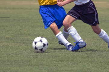 Youth Soccer players battle for the soccer ball