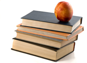 books and nectarine isolated white