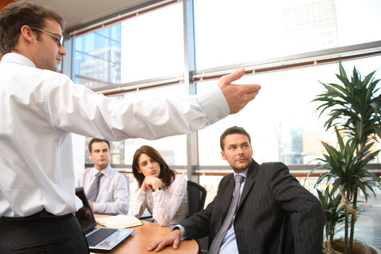 Man speaks in front of colleagues