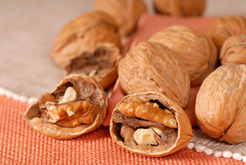 Cracked and whole walnuts on a table