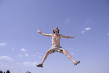 Fototapeta na wymiar healthy happy man jumping in joy of life