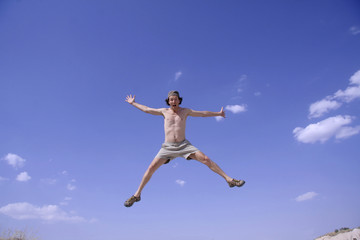 Fototapeta na wymiar healthy happy man jumping in joy of life