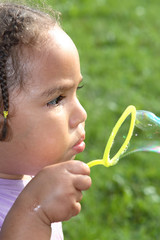 girl blowing bubbles