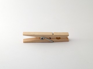 An isolated wooden clothespin