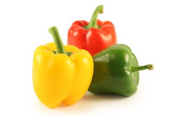 Three multi-coloured pepper isolated on white