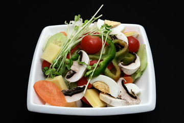 garden salad on black isolated background
