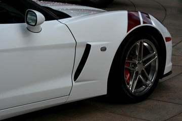 side of white supercar