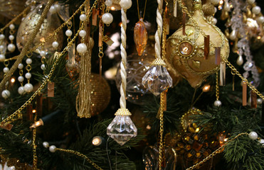 Christmas fur-tree decorated by set of gold ornaments, spheres a