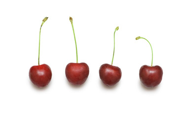 Row of cherries isolated on the white