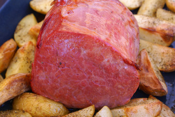 Baked corned beef with potatoes on baking tray
