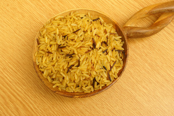 Brown rice with wild rice on the african wooden spoon