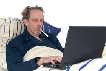 sick in bed with laptop.