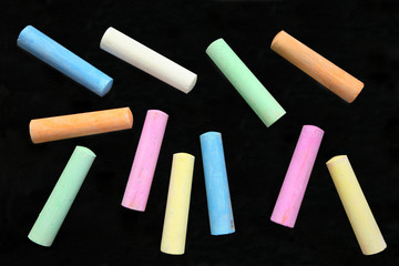 Colorful large chalk sticks on a blackboard. - Powered by Adobe