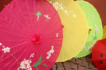 a few colorful hand crafted umbrella on floor