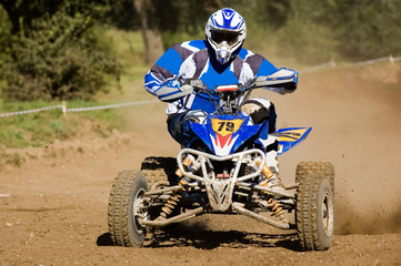Teenager on a blue quad bike sliding