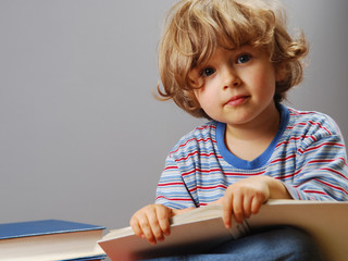 beautiful four years old reading a book