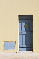 yellow wall and blue door