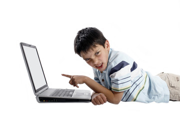 Fototapeta na wymiar young angry boy doing homework on a laptop