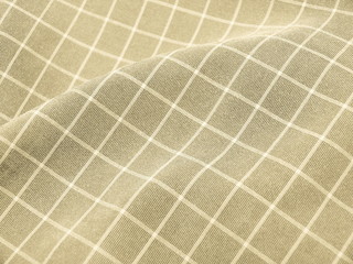 Pleated checkered beige fabric close up. Good for background.