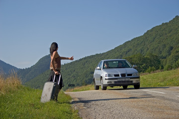 Woman making of hitch-hiking
