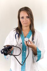 young woman doctor with sphygmomanometer and stethoscope