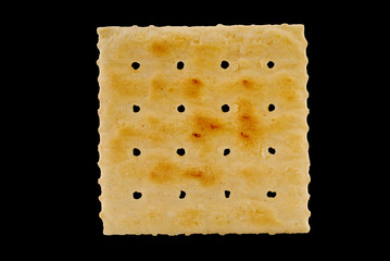 Saltine cracker on black
