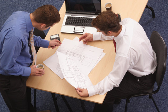 Two architects reviewing the blueprints