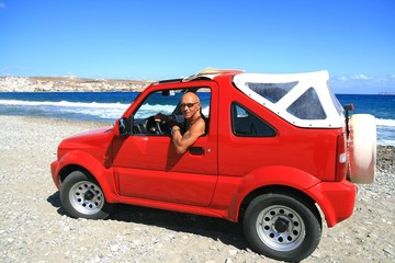 Man in red jeep