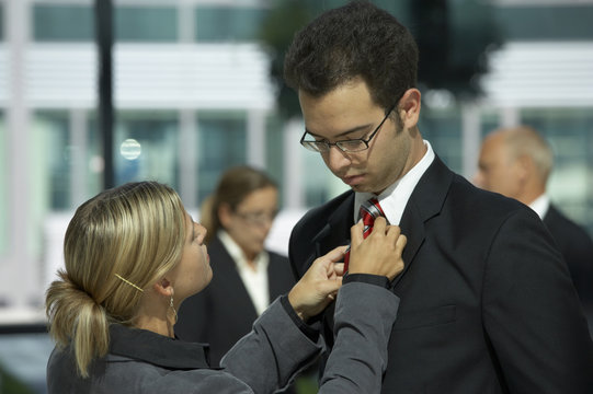 woman adjusting tie