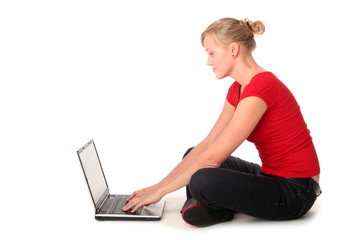 Girl sitting on floor using laptop