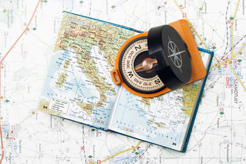 Compass and small atlas on a map