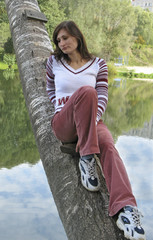 Girl sits on tree