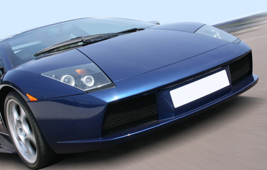 Blue super car with background motion blur