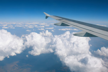 Fototapeta na wymiar Wing over the clouds