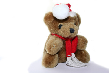 teddy bear in christmas red cap and red scarf