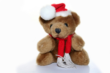teddy bear in christmas red cap and red scarf