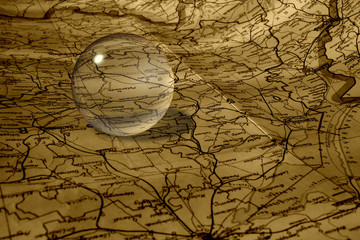 Old map and glass ball in sepia