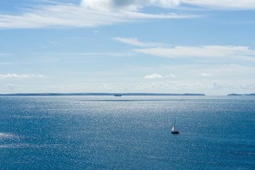 Fototapeta na wymiar Yacht Sailing on a Blue Sea