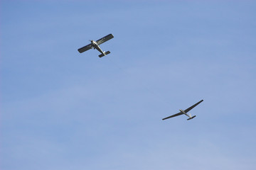 propeller-driven airplane is towing a glider