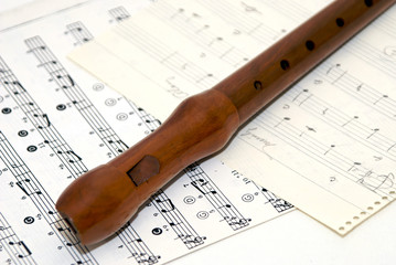 wooden flute with sheet music