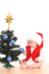 baby girl and Christmas tree
